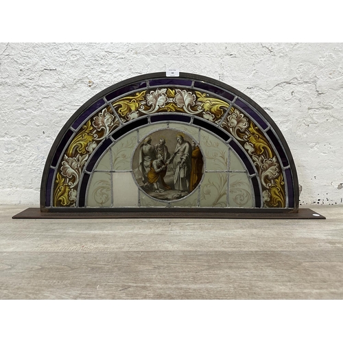 44 - A 19th century religious hand painted and stained glass window on cast metal stand - approx. 42cm hi... 