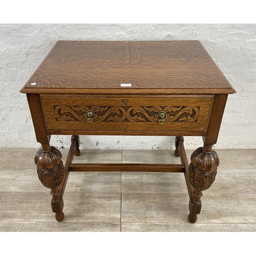 51 - A mid 20th century Jacobean style carved oak cutlery table containing EPNS cutlery - approx. 78cm hi... 