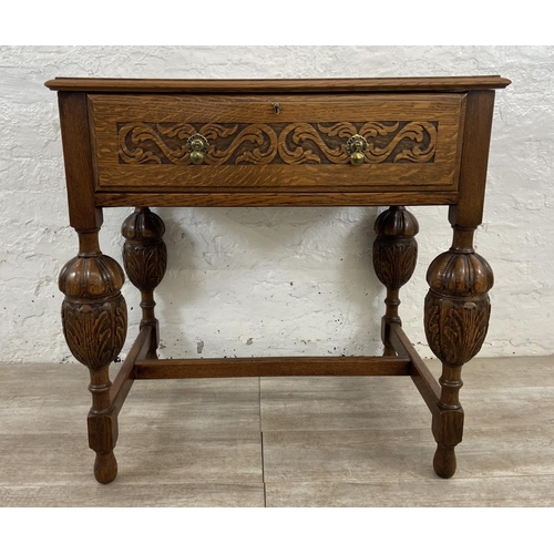 51 - A mid 20th century Jacobean style carved oak cutlery table containing EPNS cutlery - approx. 78cm hi... 