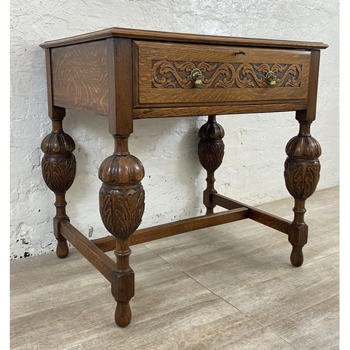 51 - A mid 20th century Jacobean style carved oak cutlery table containing EPNS cutlery - approx. 78cm hi... 