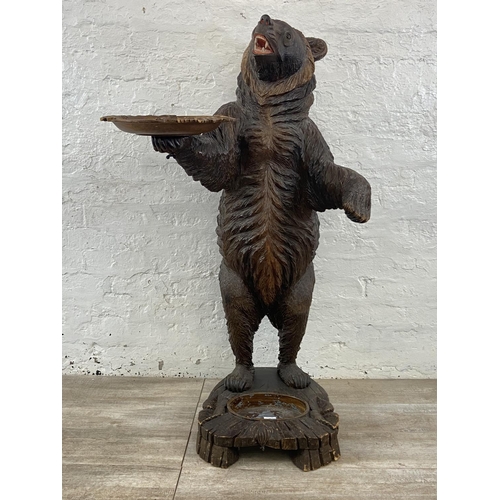 A late 19th/early 20th century Black Forest carved wooden bear free standing umbrella stick stand - approx. 130cm high