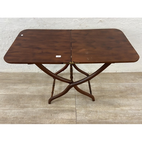 58 - A 19th century Howard & Sons mahogany folding coaching table - approx. 71cm high x 51cm wide x 102cm... 