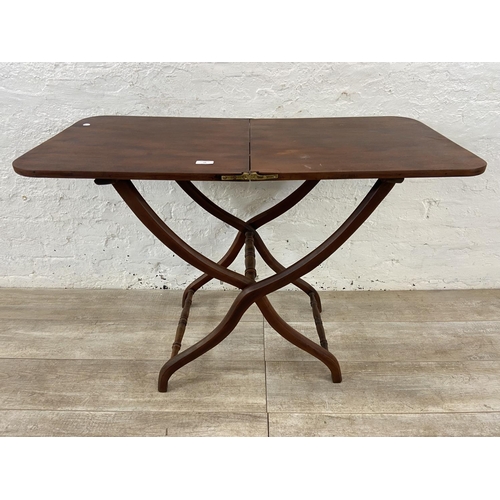 58 - A 19th century Howard & Sons mahogany folding coaching table - approx. 71cm high x 51cm wide x 102cm... 