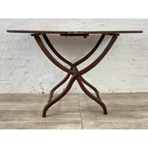 58 - A 19th century Howard & Sons mahogany folding coaching table - approx. 71cm high x 51cm wide x 102cm... 