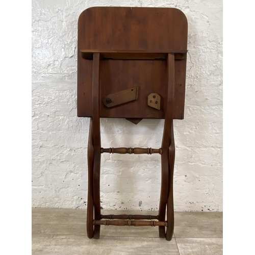 58 - A 19th century Howard & Sons mahogany folding coaching table - approx. 71cm high x 51cm wide x 102cm... 