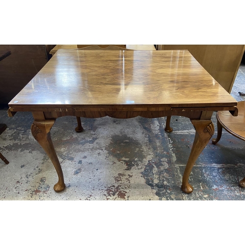 67 - A Queen Anne style walnut draw leaf dining table - approx. 77cm high x 91cm wide x 111cm long