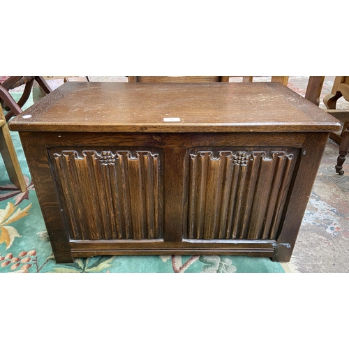 87 - A mid 20th century carved oak linenfold blanket box - approx. 46cm high x 76cm wide x 43cm deep