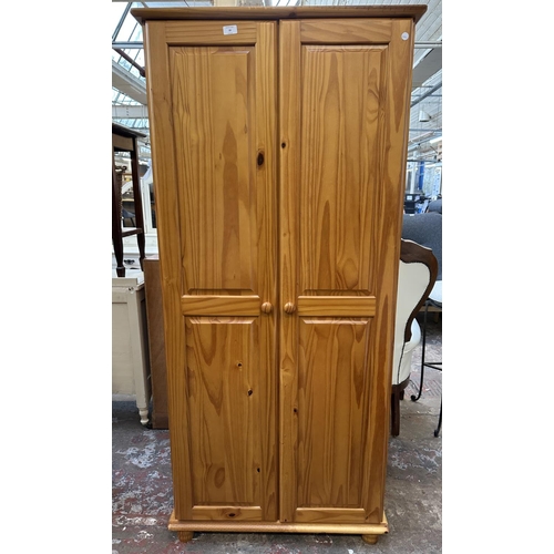 99 - A pine double wardrobe - approx. 178cm high x 82cm wide x 53cm deep