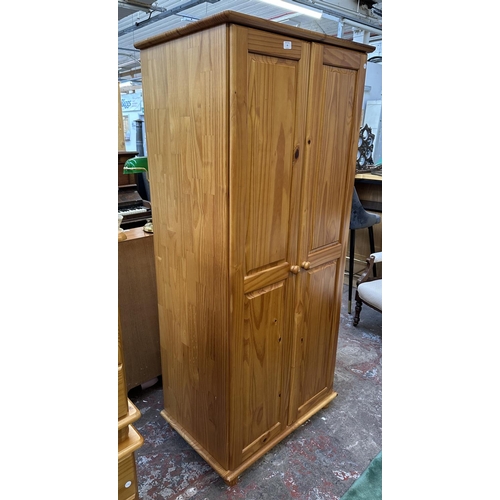 99 - A pine double wardrobe - approx. 178cm high x 82cm wide x 53cm deep
