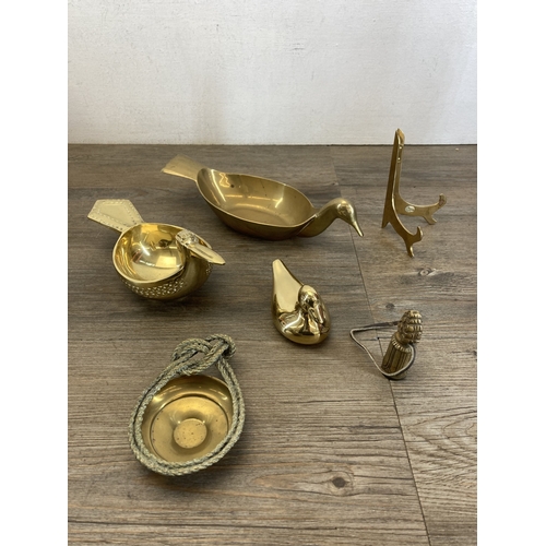 608 - A collection of metalware to include brass duck ornament, Rococo style embossed brass planter on tri... 