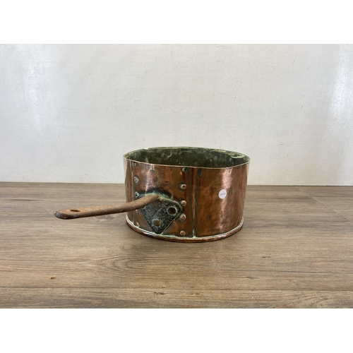 610 - A 19th century copper and brass saucepan - approx. 16cm high x 29cm diameter