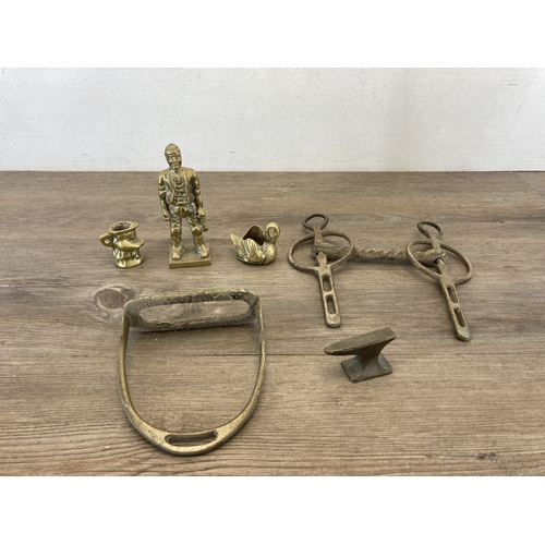 620 - A collection of brassware to include trivet stands, cannon ornament, deer figurine, pair of stirrups... 