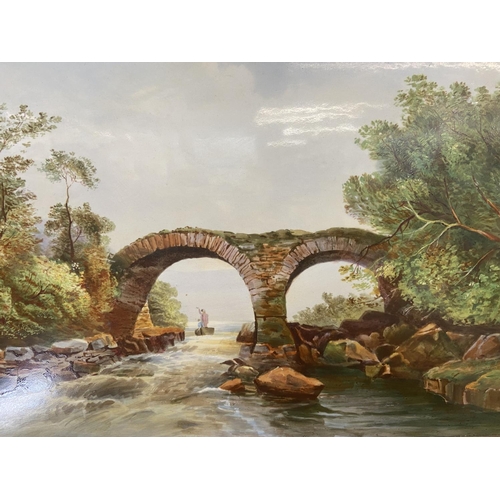 463 - A late 19th/early 20th century gilt framed oil on porcelain of a bridge and stream - approx. 28cm hi... 