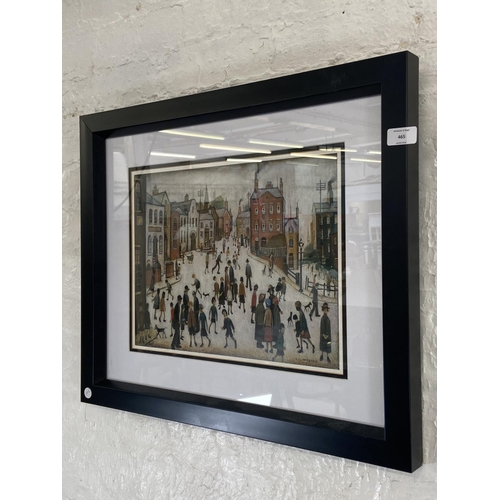 465 - A modern framed L.S Lowry print of a Manchester street scene - approx. 53cm high x 63cm wide