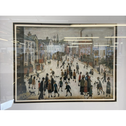 465 - A modern framed L.S Lowry print of a Manchester street scene - approx. 53cm high x 63cm wide