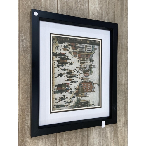 465 - A modern framed L.S Lowry print of a Manchester street scene - approx. 53cm high x 63cm wide