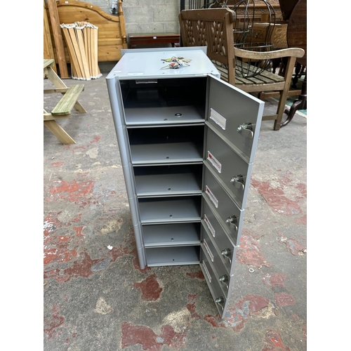 407 - A Joma grey metal six tier mailbox with two sets of keys - approx. 75cm high x 30cm wide x 37cm deep