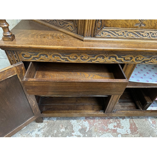 53 - A mid 20th century Jacobean style carved oak court cupboard - approx. 143cm high x 152cm wide x 52cm... 