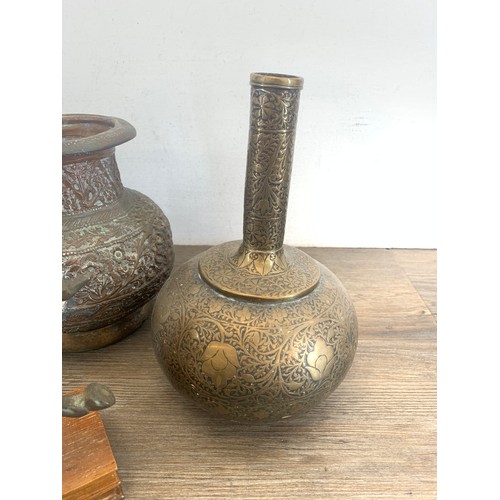 611 - Four pieces of metalware, one pair of Indian hand tooled brass vases - approx. 21cm high, one cast m... 