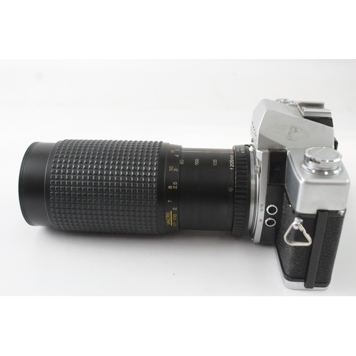 39 - A Minolta SR-T101 35mm SLR camera fitted with Bell & Howell 1:4.5 80-205mm macro zoom lens