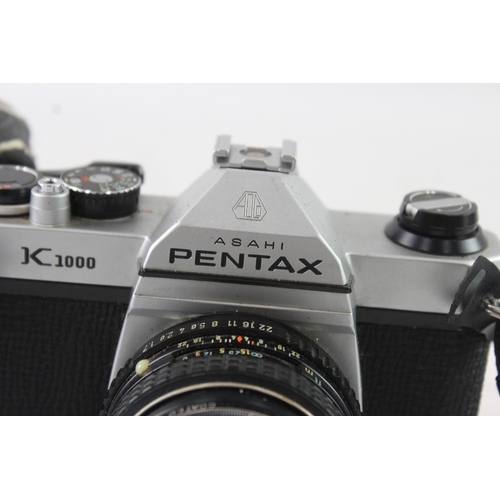 9 - A cased Asahi Pentax K1000 35mm SLR camera fitted with Pentax-M 1:1.7 50mm lens