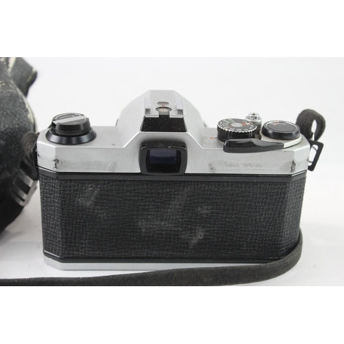 9 - A cased Asahi Pentax K1000 35mm SLR camera fitted with Pentax-M 1:1.7 50mm lens