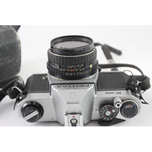 9 - A cased Asahi Pentax K1000 35mm SLR camera fitted with Pentax-M 1:1.7 50mm lens