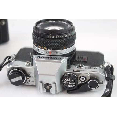 17 - A cased Olympus OM10 35mm SLR camera fitted with F.Zuiko Auto-S 1:1.8 50mm lens