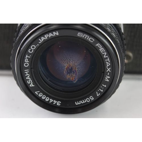 24 - An Asahi Pentax K1000 35mm SLR camera fitted with smc Pentax-M 1:1.7 50mm lens