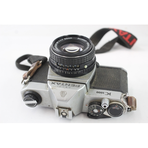 24 - An Asahi Pentax K1000 35mm SLR camera fitted with smc Pentax-M 1:1.7 50mm lens