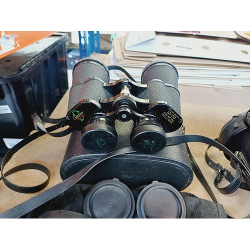 254 - Nine cased pairs of binoculars to include Greenkat, Chinon, Dollond etc.