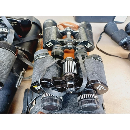 254 - Nine cased pairs of binoculars to include Greenkat, Chinon, Dollond etc.