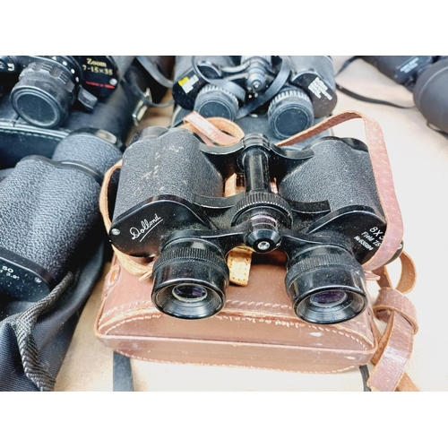 254 - Nine cased pairs of binoculars to include Greenkat, Chinon, Dollond etc.