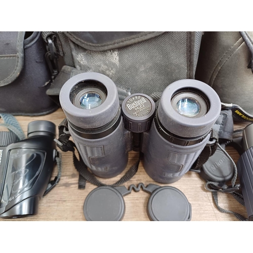 247 - Four cased pairs of binoculars, one Bushnell H2O 10x42 waterproof, one Nikon 8-24x25 pocket zoom, on... 
