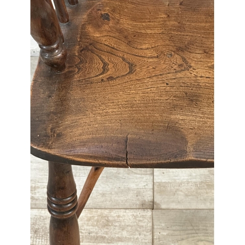 1002 - A 19th century yew wood and elm Windsor chair, stamped E. Gabbitass Worksop - approx. 88cm high x 47... 