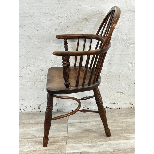 1002 - A 19th century yew wood and elm Windsor chair, stamped E. Gabbitass Worksop - approx. 88cm high x 47... 