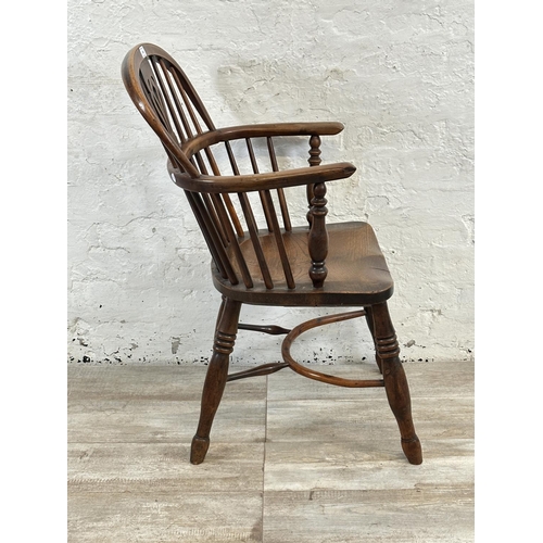 1002 - A 19th century yew wood and elm Windsor chair, stamped E. Gabbitass Worksop - approx. 88cm high x 47... 