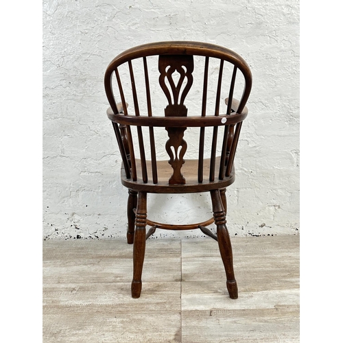 1002 - A 19th century yew wood and elm Windsor chair, stamped E. Gabbitass Worksop - approx. 88cm high x 47... 