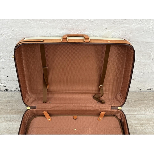 1059 - Two Italian Bojola Original Saddler cream plastic and tan leather suitcases - largest approx. 52cm h... 