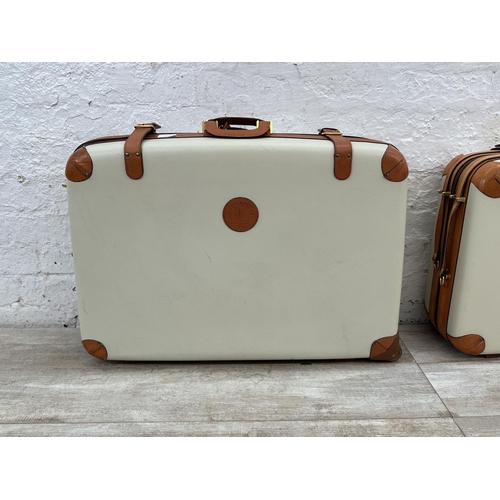 1059 - Two Italian Bojola Original Saddler cream plastic and tan leather suitcases - largest approx. 52cm h... 