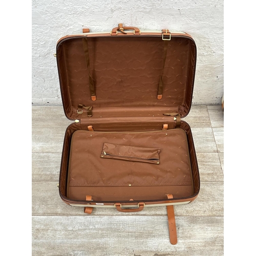 1059 - Two Italian Bojola Original Saddler cream plastic and tan leather suitcases - largest approx. 52cm h... 