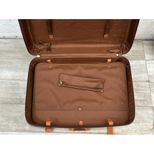 1059 - Two Italian Bojola Original Saddler cream plastic and tan leather suitcases - largest approx. 52cm h... 