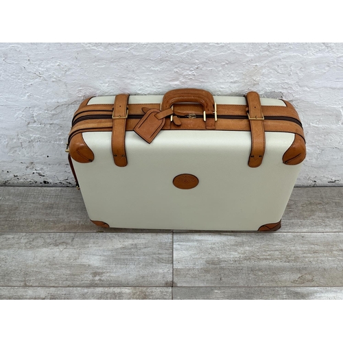 1059 - Two Italian Bojola Original Saddler cream plastic and tan leather suitcases - largest approx. 52cm h... 