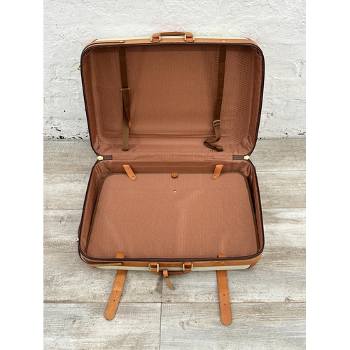 1059 - Two Italian Bojola Original Saddler cream plastic and tan leather suitcases - largest approx. 52cm h... 
