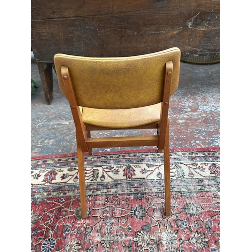 1220 - Four mid 20th century beech and tan vinyl dining chairs