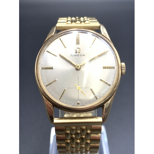 2111 - A 1960s Omega 9ct gold cased cal. 267 hand wind men's wristwatch with brushed silvered dial, baton i...