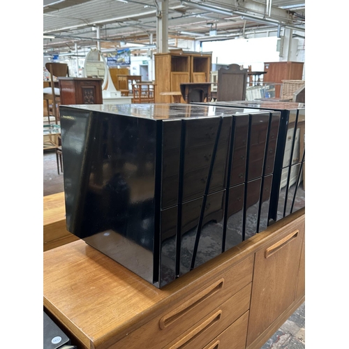 142 - A pair of modern black lacquered bedside chests of drawers - approx. 45cm high x 50cm wide x 43cm de... 