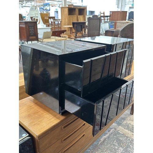142 - A pair of modern black lacquered bedside chests of drawers - approx. 45cm high x 50cm wide x 43cm de... 