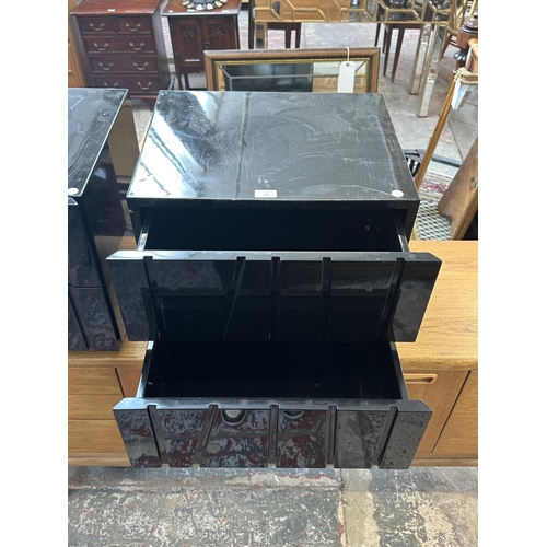 142 - A pair of modern black lacquered bedside chests of drawers - approx. 45cm high x 50cm wide x 43cm de... 