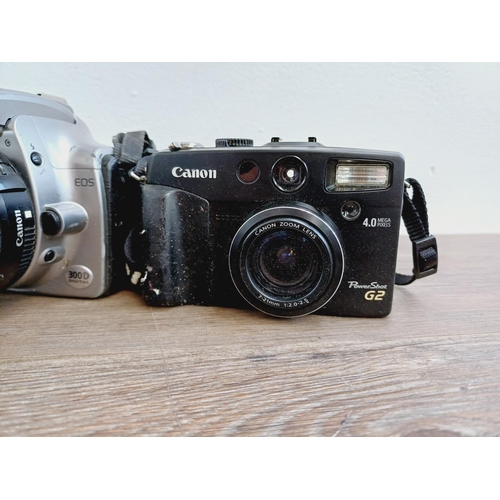 2 - Four Canon digital cameras, one EOS 300D 6mp DSLR fitted with EF-S 1:3.5-5.6 zoom lens, one EOS 300D... 